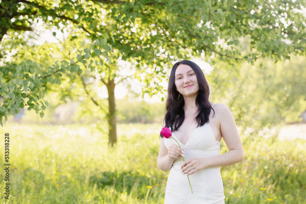young girl in white dress with pink tulips on spring park young girl in white dress with pink tulips on spring park