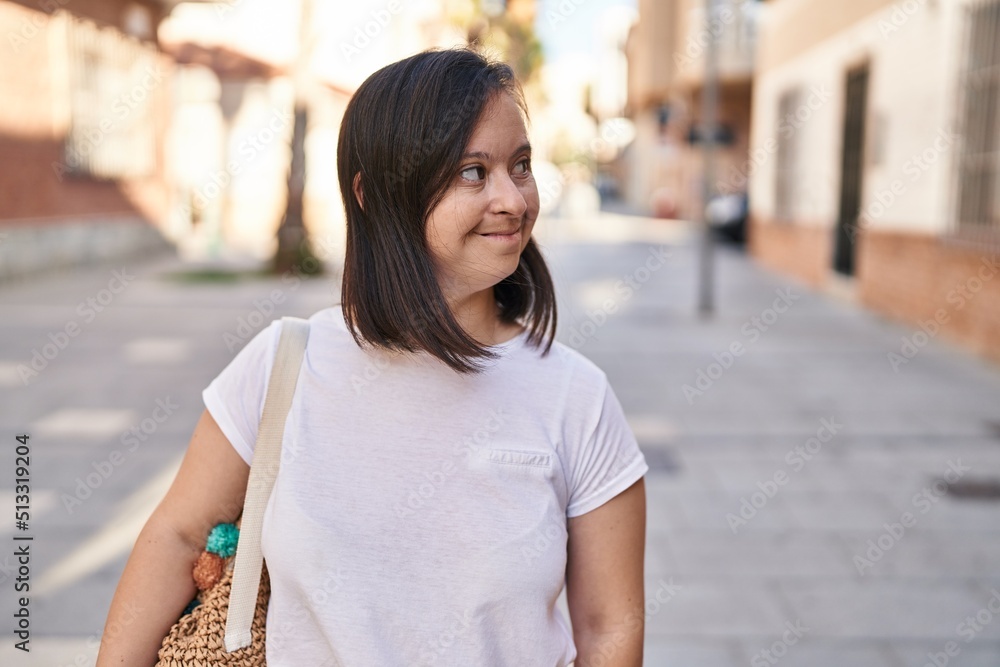Down syndrome woman smiling confident standing at street