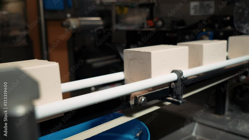 Yeast production. Production of butter, spread, margarine, yeast. Conveyor of the food industry. Rectangular pieces of product move along the conveyor line before packing. Yeast production. Production of butter, spread, margarine, yeast. Conveyor of the food industry. Rectangular pieces of product move along the conveyor line before packing.