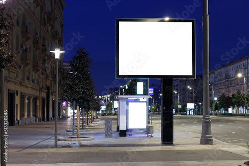 Large horizontal billboard in the night city. Expanse of the night city. Mock-up.
