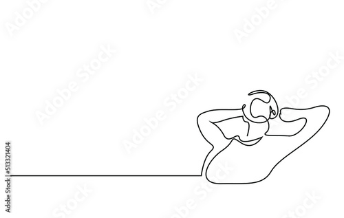 a young man puts his hands behind his head and rests relaxed