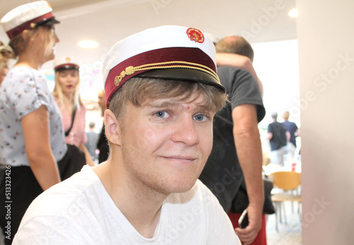 Young happy Danish male student with a student cap at graduation photo