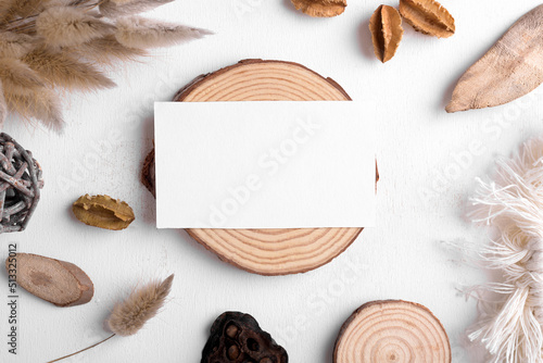 Boho business card mockup template, empty stationery card with dry plants, wood and boho decor on a white background and design element for wedding invitation, rsvp, thank you card, greeting photo