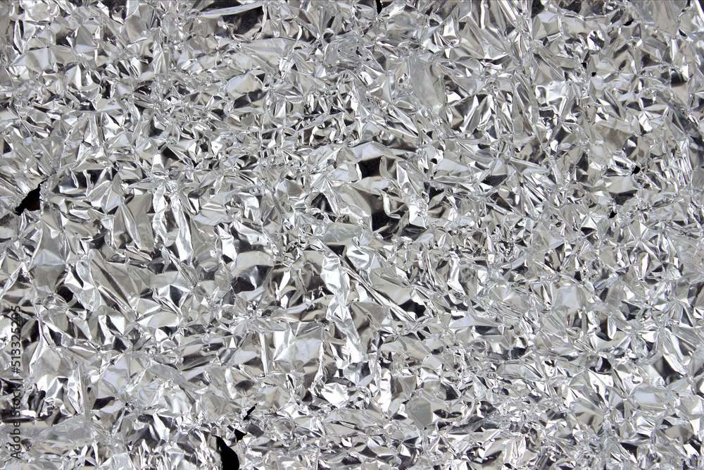 crumpled silver foil texture close up. Abstract background crumpled silver foil texture close up. Abstract background