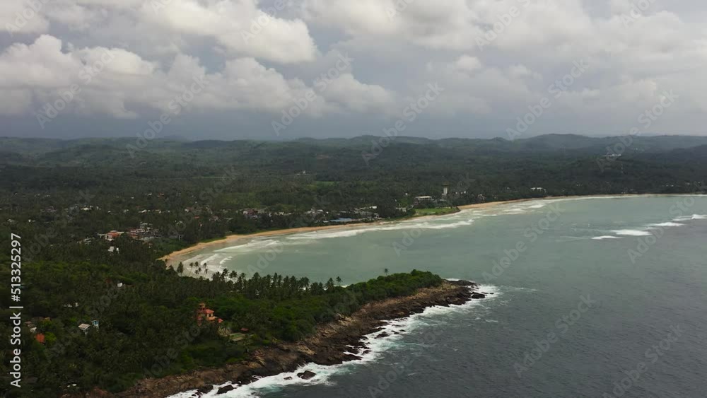 Top view of coast with a beach and hotels among palm trees. Dickwella Beach, Sri Lanka. Top view of coast with a beach and hotels among palm trees. Dickwella Beach, Sri Lanka.