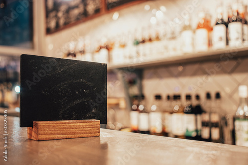 blank chalk tablet on coffee shop bar counter with blurred background