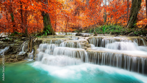 Fototapeta Naklejka Na Ścianę i Meble -  Amazing in nature, beautiful waterfall at colorful autumn forest in fall season	