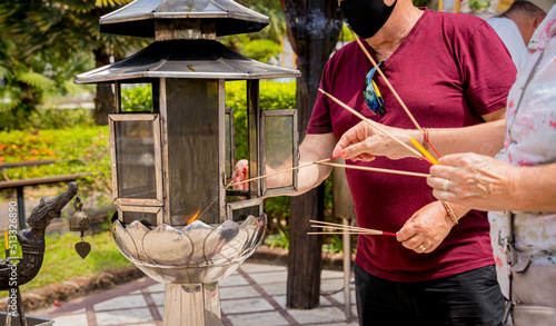 Ritual of burning incense sticks at the big Thai temple