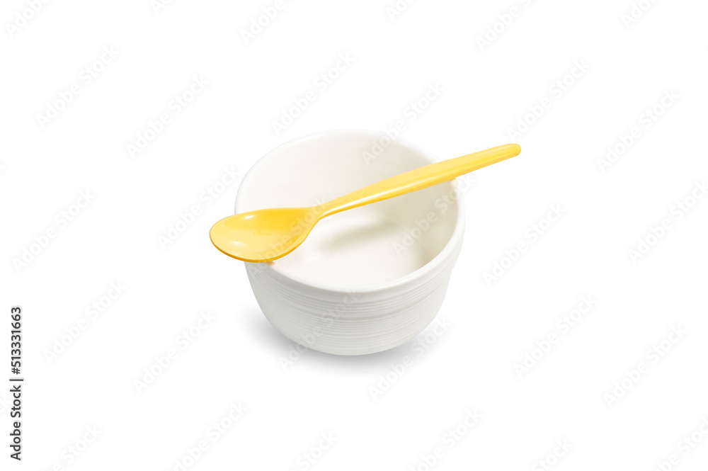white cup and yellow spoon on white background white cup and yellow spoon on white background