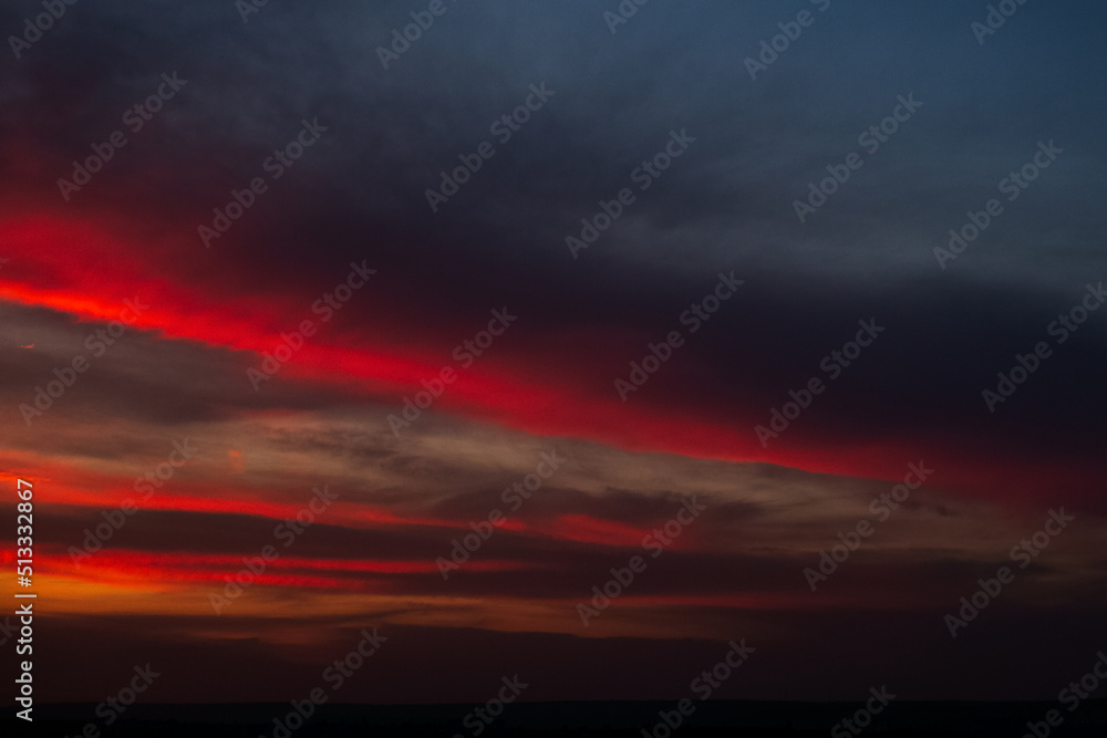 Fototapeta premium Beautiful landscape of sunset with dark colourful clouds. Natural background.