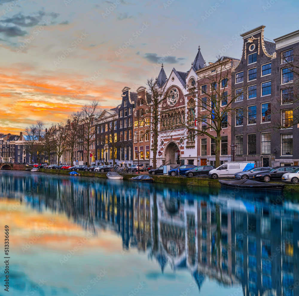 Long exposure shot of beautiful Dutch buildings during dusk in Amsterdam, Netherlands