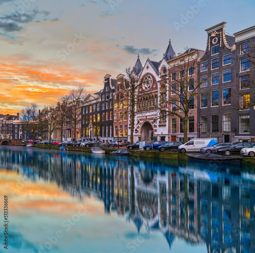 Long exposure shot of beautiful Dutch buildings during dusk in Amsterdam, Netherlands