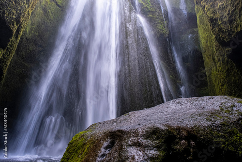 Scenic bottom up view of Glj  frafoss waterfall from a cave in Iceland  amazing view of secret waterfall landscape