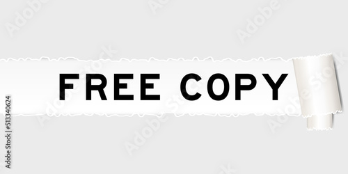 Ripped gray paper background that have word free copy under torn part