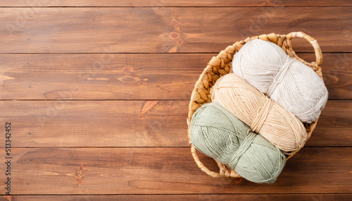 Canvas Print pastel colored yarn wool in a basket on wooden background