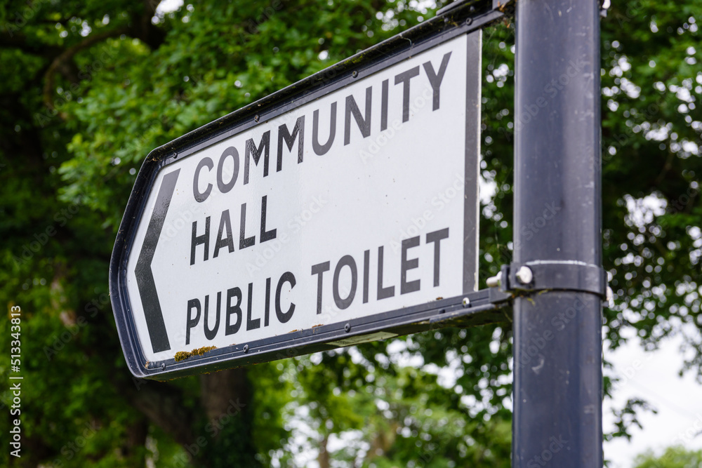 Sign to the community hall and public toilet in a rural village. Sign to the community hall and public toilet in a rural village.
