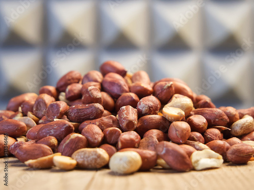 Heap of roasted peanuts, side view. Peanuts close up. Spanish Peanuts in pile