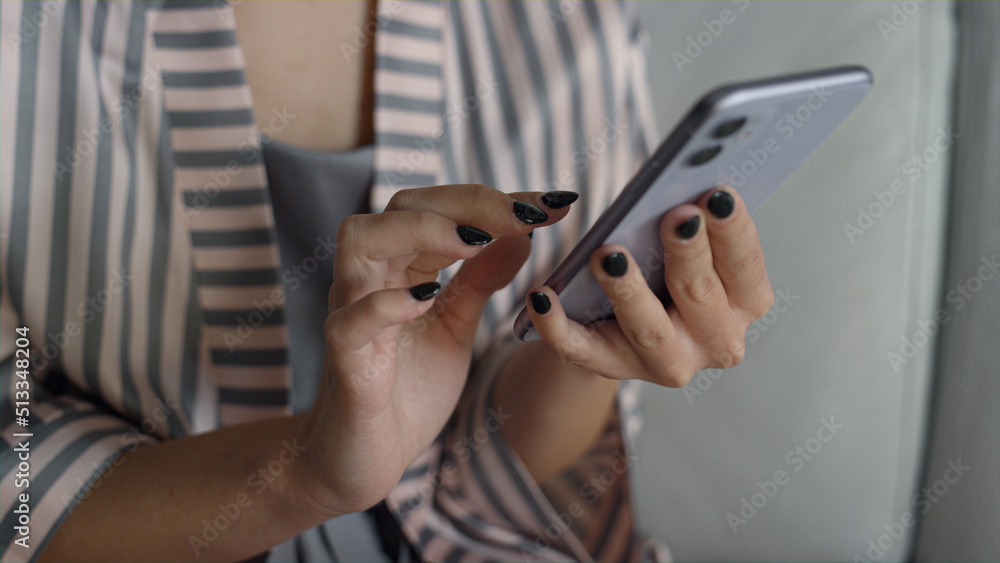 Blogger hands holding smartphone in pajamas closeup. Manager working home office