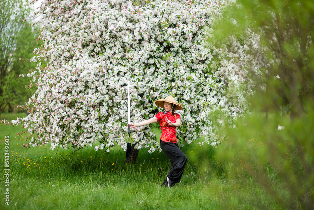 Asian woman with sword training with tai chi in the park, chinese martial arts, healthy lifestyle concept. Asian woman with sword training with tai chi in the park, chinese martial arts, healthy lifestyle concept.