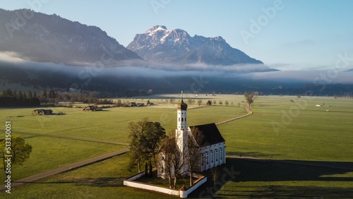 View of the St. Coloman church in Allgaeu on the sunrise photo