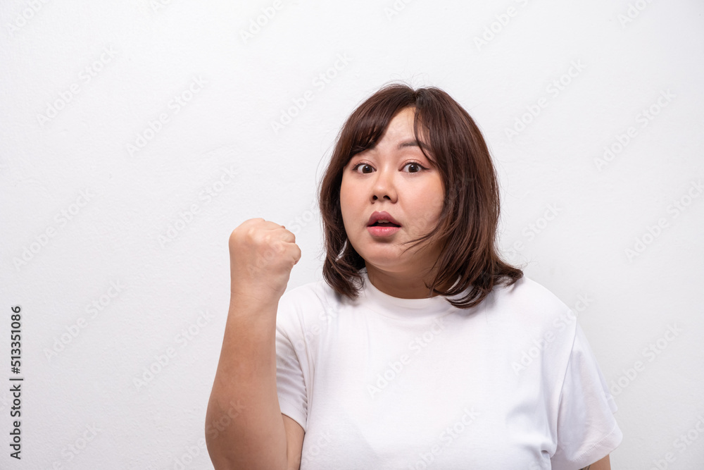 Young beautiful Asian oversize women smile with positive emotion, feeling happy and proud with her body size. Portrait shot on white background with copy space. Young beautiful Asian oversize women smile with positive emotion, feeling happy and proud with her body size. Portrait shot on white background with copy space.