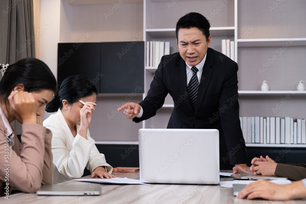 Asian men manager scold and angry with their employee inside of office meeting room with upset and stress worker. Business failure. Problem in working office issue. Asian men manager scold and angry with their employee inside of office meeting room with upset and stress worker. Business failure. Problem in working office issue.