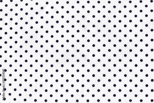 Light white silk fabric with small dark blue polka dots. Background of natural white silk fabric. Summer lightweight material.