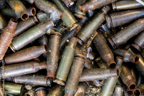 used shells from 5.45 caliber ammunition (from AK-74 5.45×39mm), rust and erosion marks are visible, background