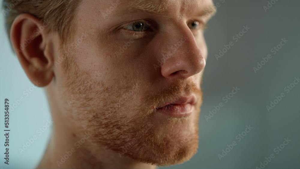 Fototapeta premium Ginger businessman looking distance closeup. Man studying document thoughtfully