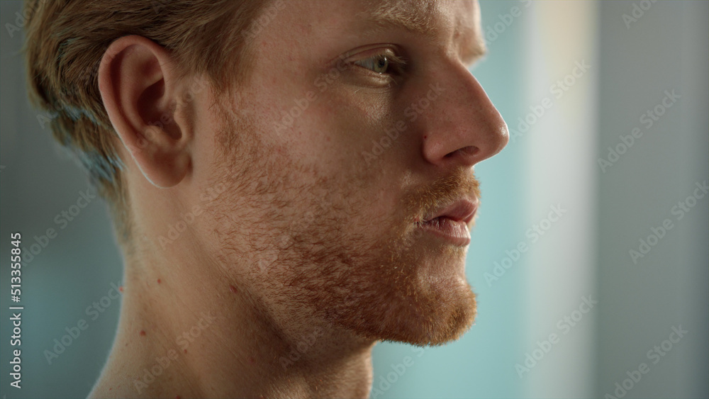 Obraz premium Serious man face expression closeup. Tired ginger worker resting after hard day