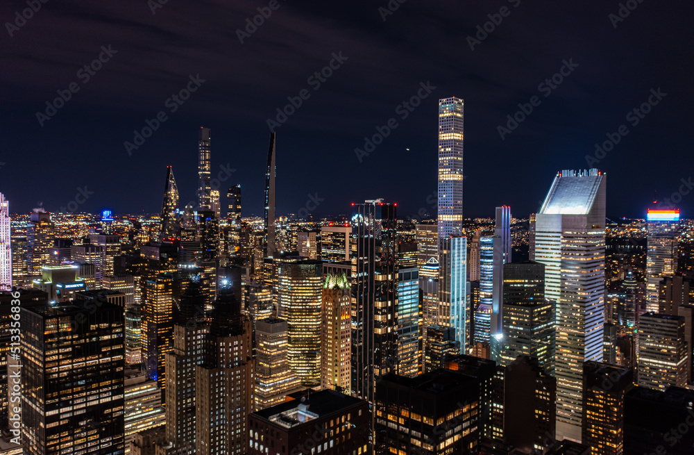 Modern residential towers in urban borough. Illuminated downtown skyscrapers at night. Manhattan, New York City, USA