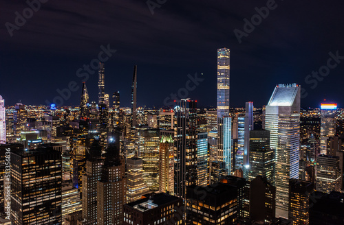 Modern residential towers in urban borough. Illuminated downtown skyscrapers at night. Manhattan, New York City, USA © 21AERIALS