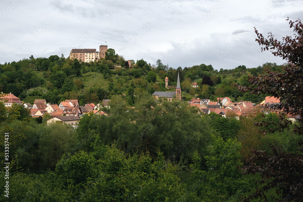 The old castle Gamburg on the top of the hill. With the village Gamburg and the river Tauber in the foreground.