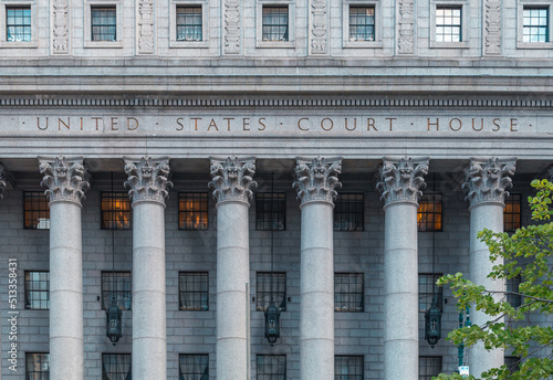 The main entrance of the Thurgood Marshall US Courthouse in NYC is listed on the National Register of Historic Places. The Corinthian columns and the frieze are carved with a detailed floral design. photo