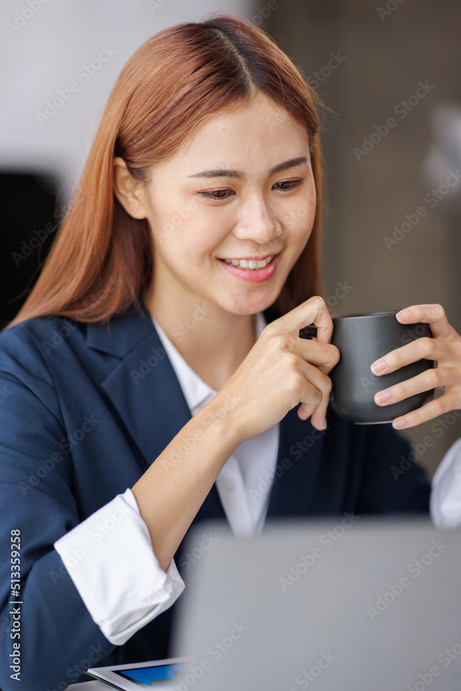 Asian Business woman using calculator and laptop for doing math finance on an office desk, tax, report, accounting, statistics, and analytical research concept Asian Business woman using calculator and laptop for doing math finance on an office desk, tax, report, accounting, statistics, and analytical research concept
