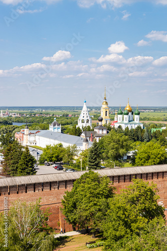 above view of wall and churches of Kolomna Kremlin and Bobrenev Monastery on horizon in Old Kolomna city on summer day from bell tower Church of St John the Evangelist