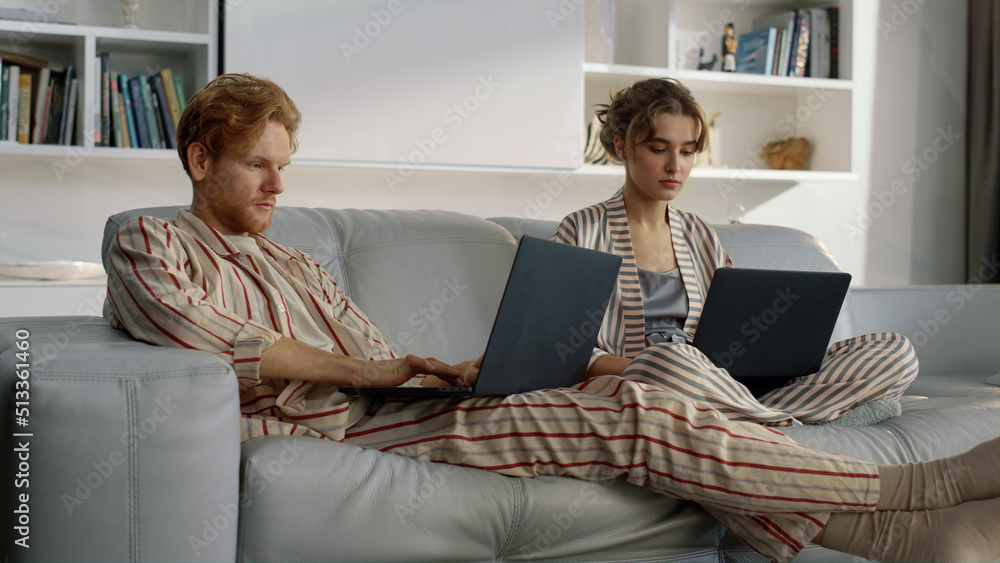 Serious couple working home together closeup. Managers browsing at remote office Serious couple working home together closeup. Managers browsing at remote office
