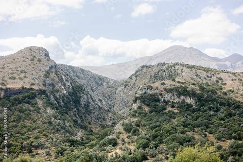 Aerial shot of the lush mountains at the Kourtaliotis Gorge in Rethymno, Greece under a cloudy sky photo