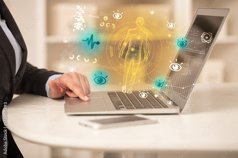 Doctor working on laptop with healthcare concept Doctor working on laptop with healthcare concept