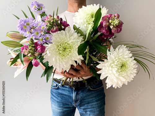 Wallpaper Mural Man holding bouquet of fresh beautiful spring flowers charming flowers as a gift for mother, father, girlfriend or wife. Present or gift. postcard concept idea Torontodigital.ca