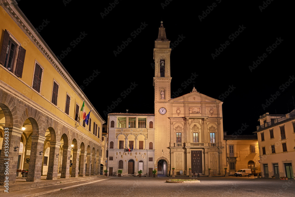 Montevarchi, Arezzo, Tuscany, Italy: night view of the main square Piazza Varchi with the ancient church Collegiata di San Lorenzo, the medieval building Palazzo del Podesta and the Town Hall