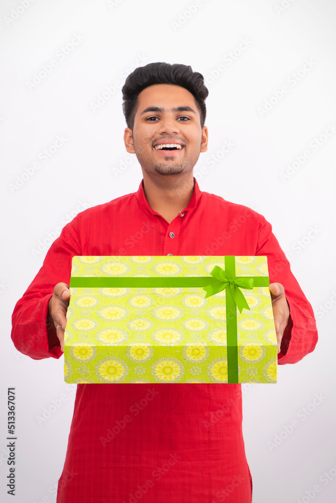 Happy man giving gift box with excitement, during festive season Happy man giving gift box with excitement, during festive season