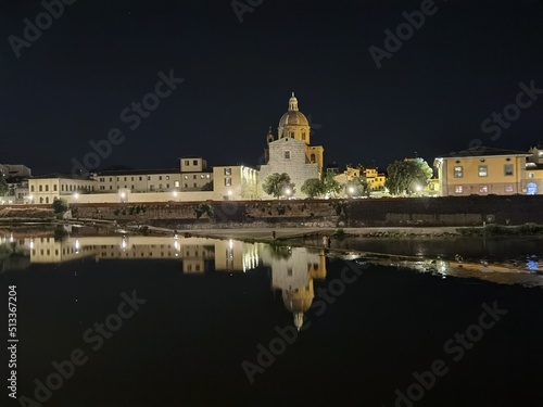 The dome of the church of San Frediano reflected in the calm waters of the Arno river in Florence. photo