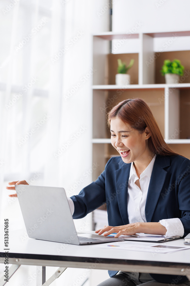 Happy excited young Asian woman with a laptop at home sitting in-home office, Emotional girl feeling glad and happy Happy excited young Asian woman with a laptop at home sitting in-home office, Emotional girl feeling glad and happy