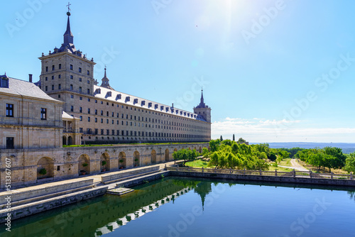 Side facade of the Escorial monastery and water reservoir with gardens, copyspace.