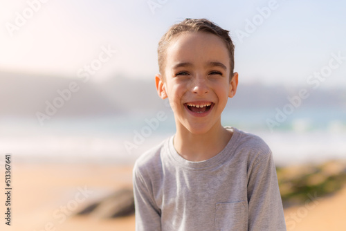 Very cheerful and happy boy on the beach