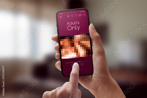 Woman watching porn videos on her smartphone photo
