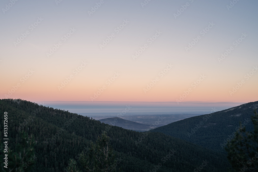 Foggy valley at dawn, with beautiful tones in the clear sky