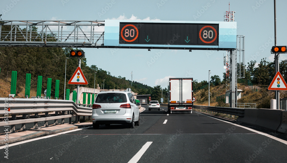 Modern freeway with digital traffic signs. Speed limits. Observance of ...