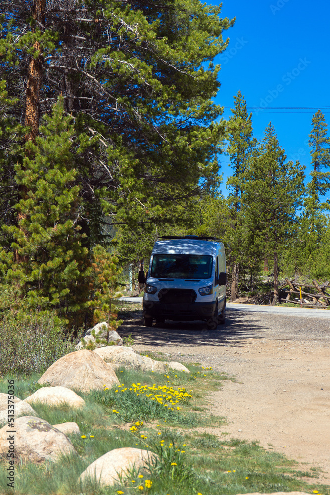 Camper van in the shade high up in the Rocky Mountains of Colorado